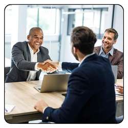 Business professionals shaking hands after a successful introduction